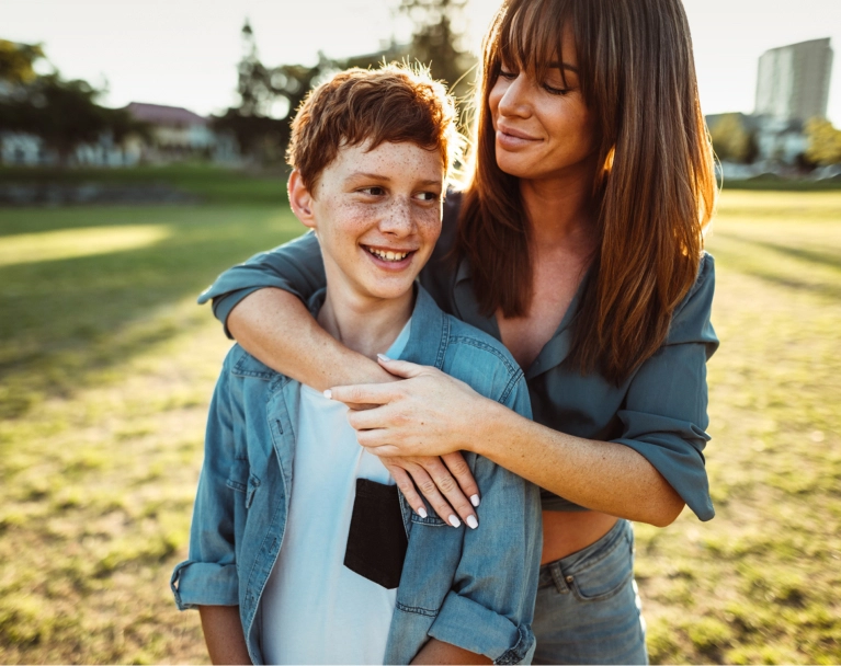 Mother and son embracing outside