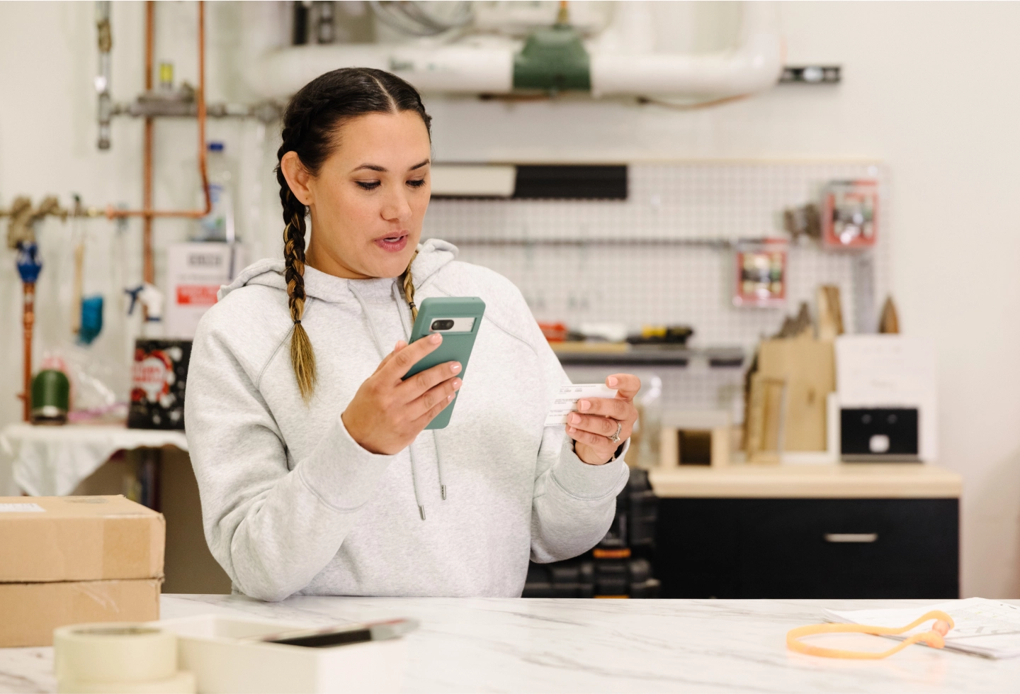 woman in workshop with smartphone
