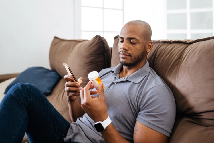 Man on sofa with medication
