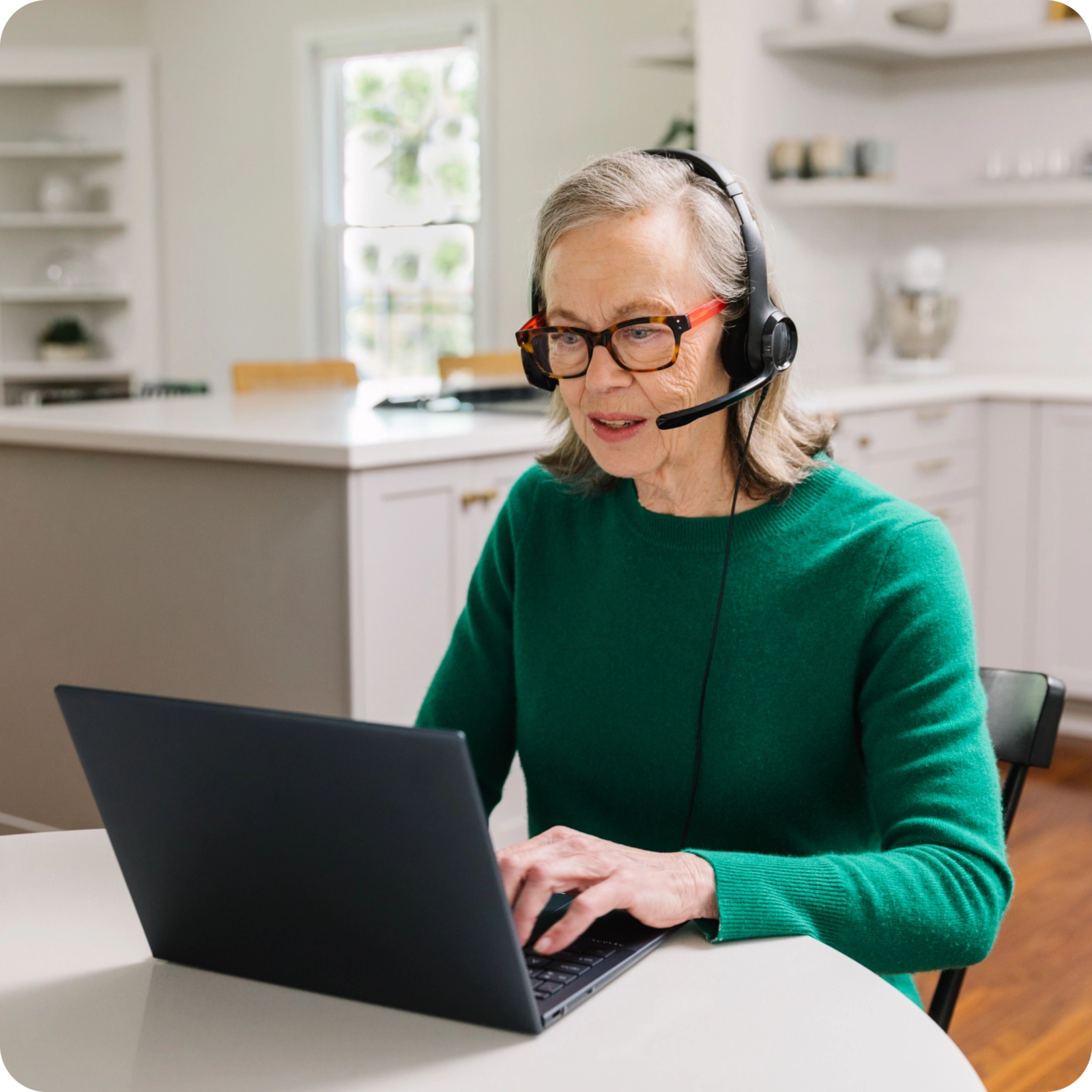 Woman with a headset on a computer