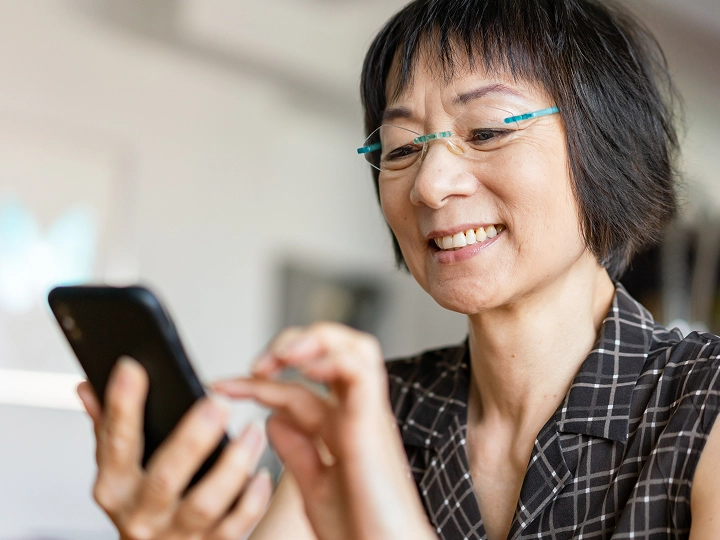 Older woman using the Included Health app on her phone