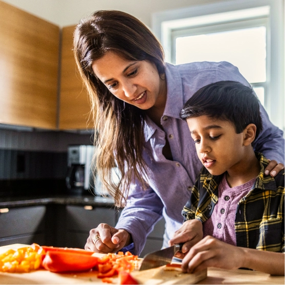 mother and son cutting bell pepper