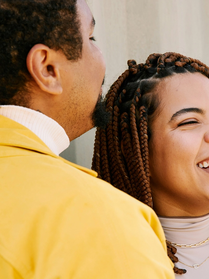 crop of two adults holding each other

