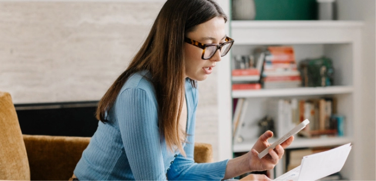woman on smartphone reading medical bill