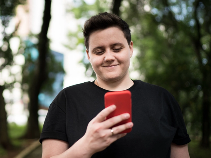 Person smiling at phone