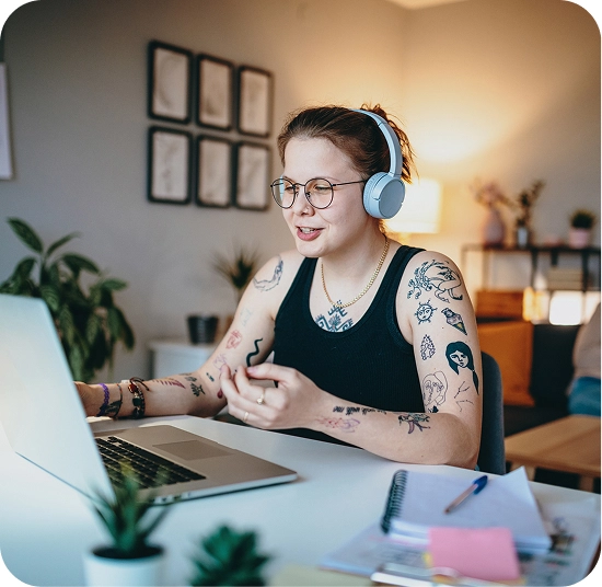 Woman wearing headphones and working on a computer