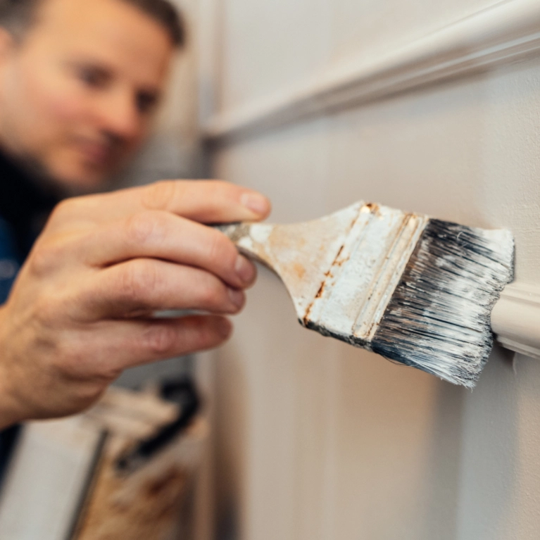close up of hand and brush painting