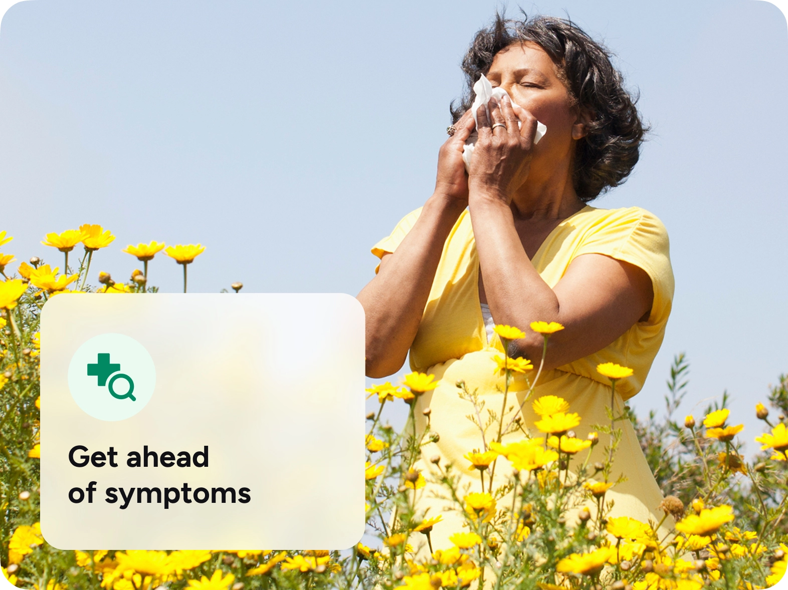 A woman sneezing into a tissue surrounded by yellow flowers