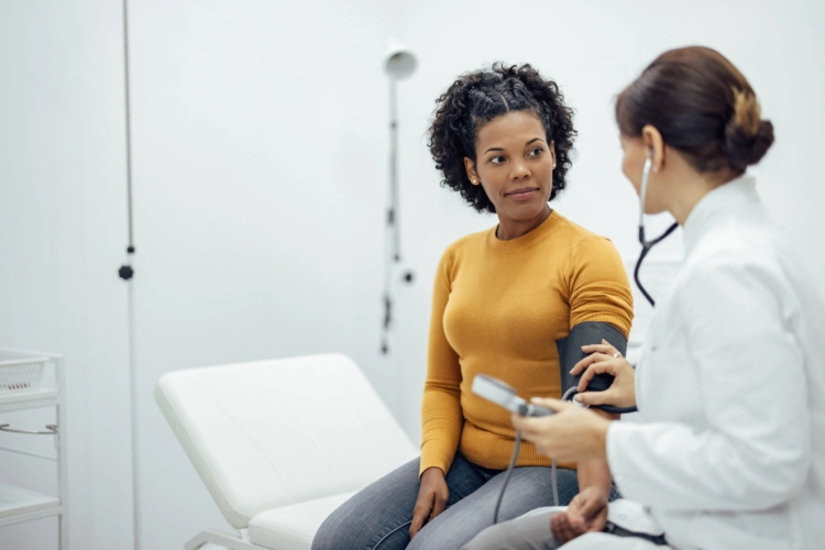 A woman speaking with a doctor.