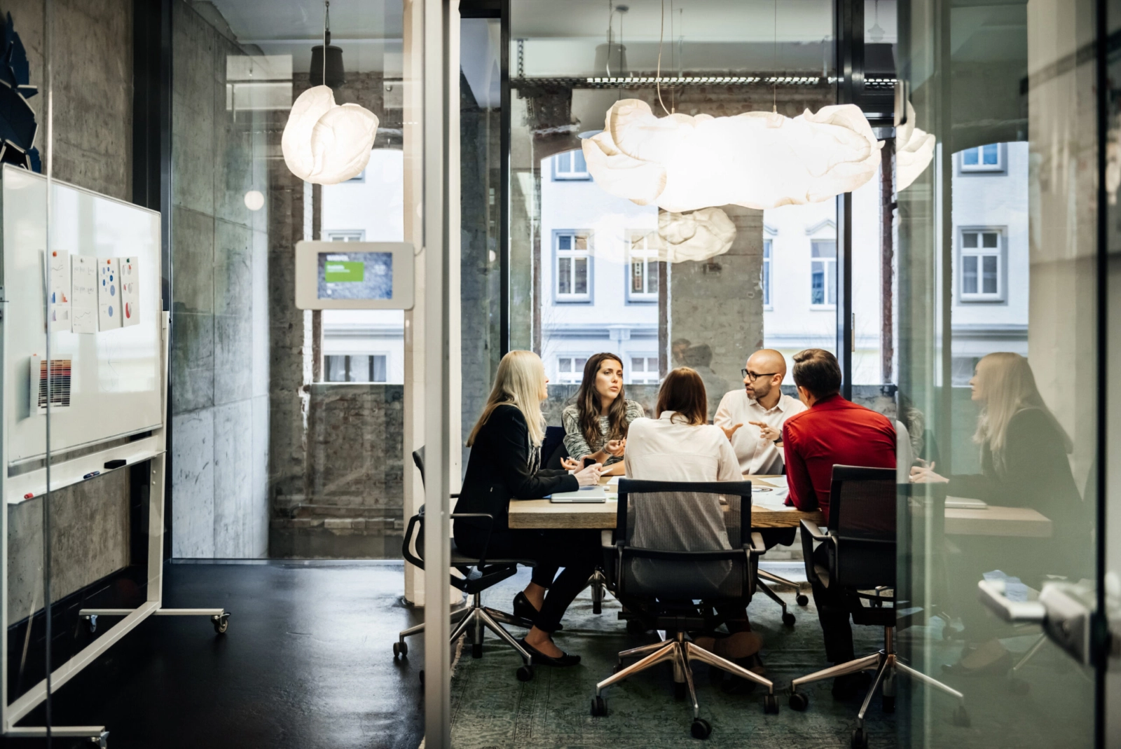 A generic header image showing coworkers in a conference room collaborating.