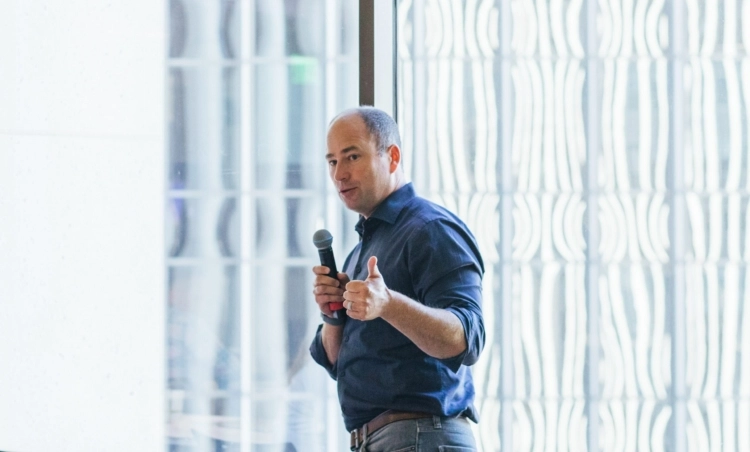 A header image showing Owen Tripp speaking at an event.