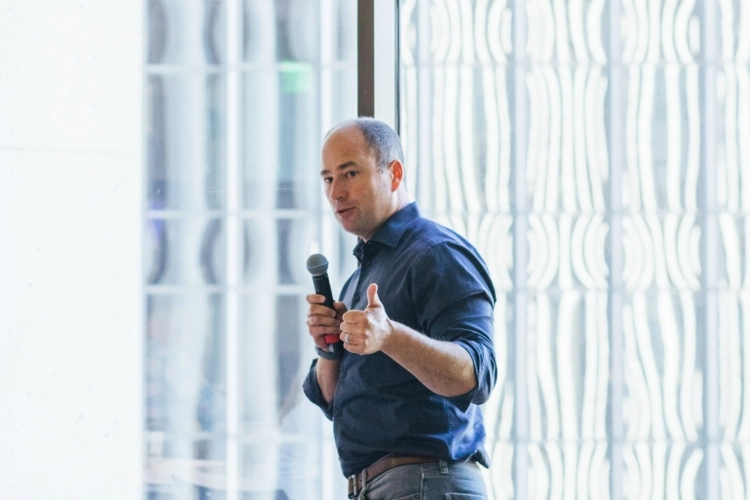 A header image showing Owen Tripp speaking at an event.